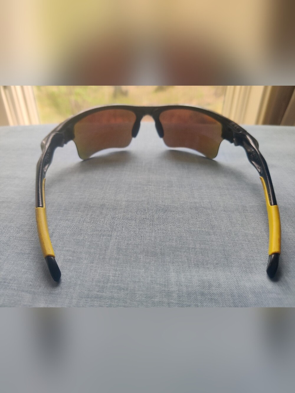 Oakley Black Sunglasses with Yellow Temple Accents and Brown/Amber Lenses